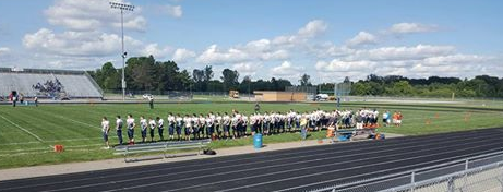 School Chooses Not To Play National Anthem During Football Game, Football Team Stands For It Anyways Featured