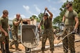 U.S. Marines work together to pour cement into the foundation of the Republica de Cuba School in Puerto Lempira, Honduras, Aug. 17.