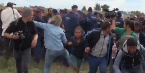 Camerawoman Who Tripped Migrants In Hungary Gets Charged With “Breach Of Peace” Featured