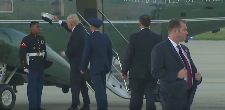 (VIDEO) President Trump runs after Marine’s hat twice to pick it up for him after it blows off Featured