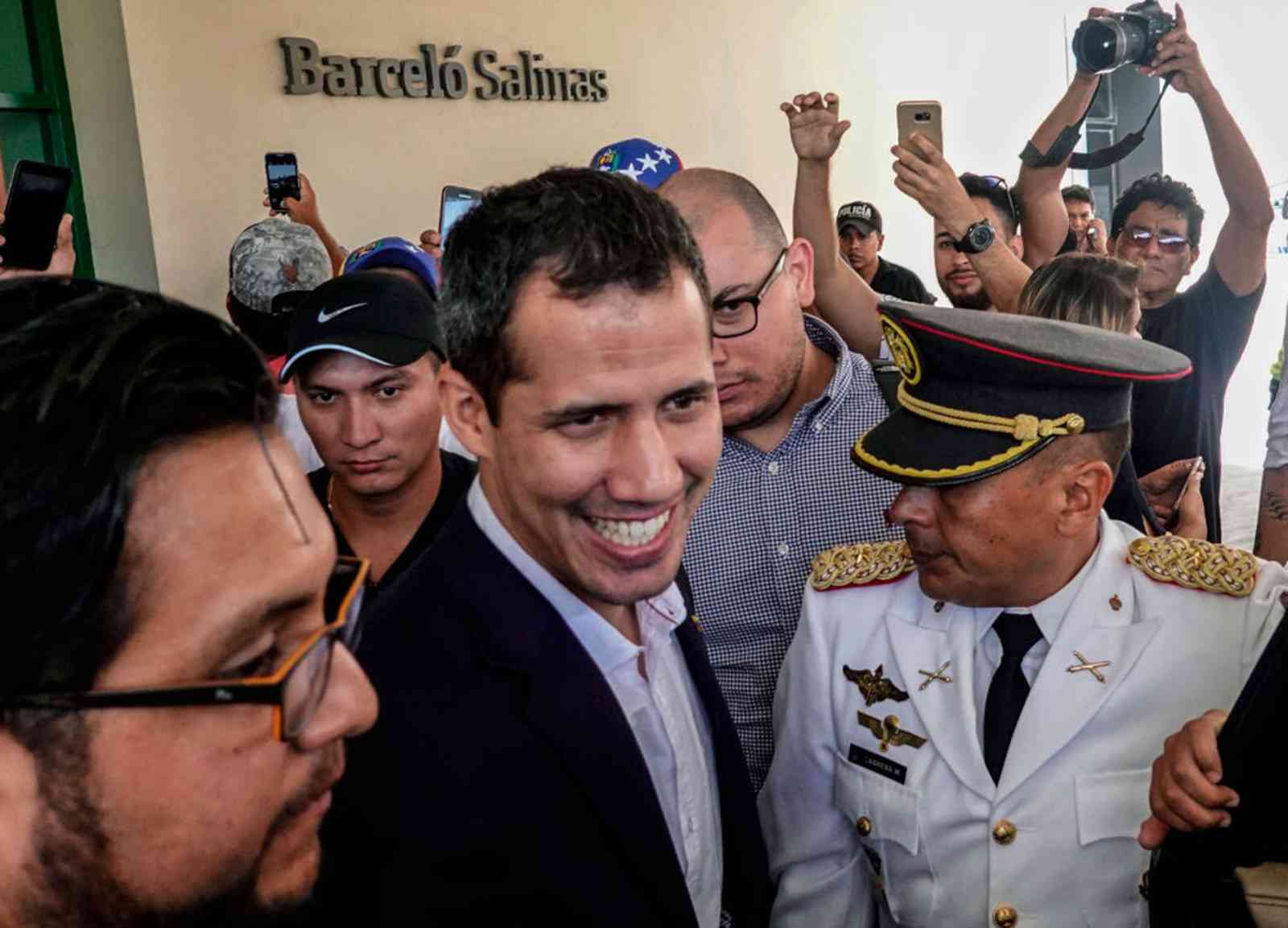 Venezuela’s opposition leader Juan Guaido returns home, risking arrest